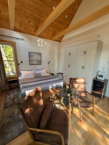 a bedroom with a bed and a table and chairs at Dock 124 - Adults Only, Waterfront B&B in Tobermory