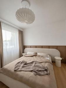 a bedroom with a bed with a robe on it at oto harmonia in Rąbinek +7 photos