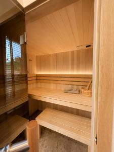 an empty sauna with wooden benches in a room at oto harmonia in Rąbinek