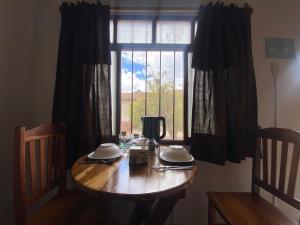 a wooden table in a room with a window at El Nido in Samaipata