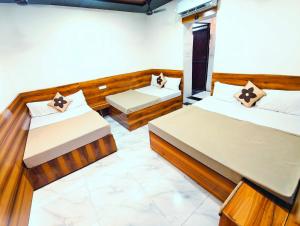 a room with two beds in a room at HOTEL OM PALACE NEAR MAHAKALESHWAR TEMPlE in Ujjain