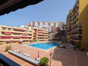 a view of a swimming pool in a building at CHC - Olivia Sunset II in Puerto de Santiago +4 photos