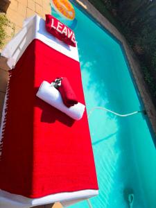 a red and white bird house in a swimming pool at Nikkita Wellness Spa in Pretoria