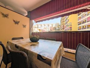 a dining room with a table and chairs and a window at CHC - Olivia Sunset II in Puerto de Santiago