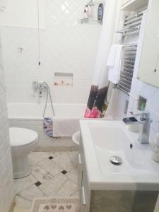 a white bathroom with a toilet and a sink at La Casetta in Genoa