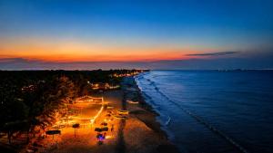 a view of a beach at night with the ocean at Sheen Coast Beach Cabana in Nilaveli