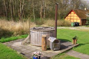 a trash can and a tv in a yard at The Lodge in Borre