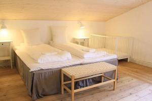 a bedroom with a large bed with a crib at The Lodge in Borre