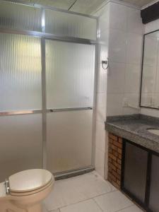 a bathroom with a shower with a toilet and a sink at Fazenda Vista Soberba in Nova Friburgo
