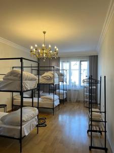 a room with four bunk beds and a chandelier at Hostel Velvet Vouge in Yerevan
