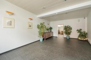 an empty room with potted plants on the walls at jutta in Mechelen