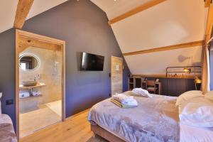a bedroom with a large bed and a shower at Domaine Le H in Munster +42 photos