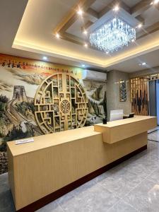 a lobby with a large painting on the wall at zhiyuanta hotel in Vientiane