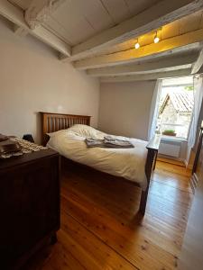 a bedroom with a large bed and a window at Le Nid Douillet in Chirac +21 photos