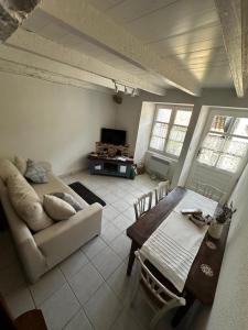a living room with a couch and a table at Le Nid Douillet in Chirac