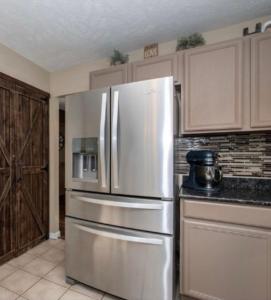 a kitchen with a stainless steel refrigerator and cabinets at The Universal Home Stay in Akron +14 photos