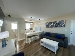 a living room with a couch and a table at Sails Resort Motel in St. Pete Beach