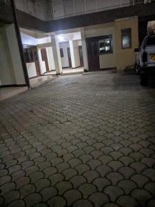 an empty parking lot with a car parked in it at Masaka BnB in Masaka