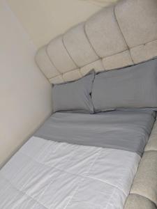 a bed with two pillows on it in a room at Masaka BnB in Masaka