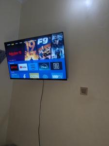 a flat screen tv hanging on a wall at Masaka BnB in Masaka