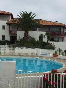 a swimming pool in front of a house at Studio Haut De Bordagain Ciboure in Ciboure
