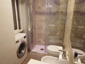 a bathroom with a shower and a toilet and a sink at La Casa del Principe in Alì +8 photos
