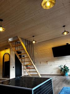 a staircase in a room with a wooden ceiling at kesis chalet in Borjomi