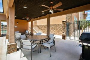 a patio with a table and chairs and a tv at Holiday Inn Express Silver City by IHG in Silver City