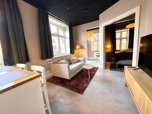 a living room with a couch and a bedroom at Randalín in Åkirkeby