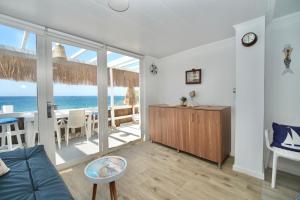 a living room with a view of the ocean at Seaside Beach Chalet in Anfeh PEARL in Anfah