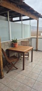 a wooden table and a bench and a potted plant at The Loft'y #3 in Famara