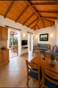 a living room with a couch and a table at Delphinus Villa Nefeli in Agios Nikitas
