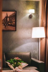 a room with a couch and a lamp and a picture at Hotel Saranda Butrinti, Affiliated by Meliá in Sarandë