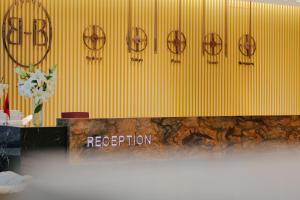 a yellow wall with a sign that reads reception at Hotel Saranda Butrinti, Affiliated by Meliá in Sarandë +37 photos