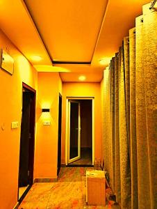 a hallway of a building with a room with columns at hotel shivalik palace in Dhanbād
