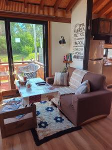a living room with a couch and a table at Pinot Noir in Piriápolis