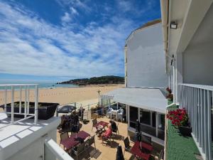 a view of the beach from the balcony of a building at Beau Rivage in St. Brelade