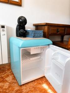 an open refrigerator with a coffee maker on top of it at Soutullo Praia in Sanxenxo