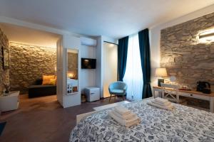 a bedroom with a bed and a stone wall at N'haidea - AgriFarm e B&B in Lettere