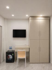 a room with a desk and a tv and a chair at Dreamora Corner Hotel in Hanoi