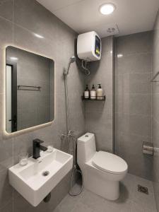 a bathroom with a white toilet and a sink at Dreamora Corner Hotel in Hanoi