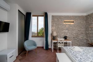 a room with a bed and a table and a window at N'haidea - AgriFarm e B&B in Lettere
