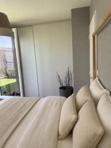 a bedroom with a bed with pillows and a window at l'arc logement in Strasbourg