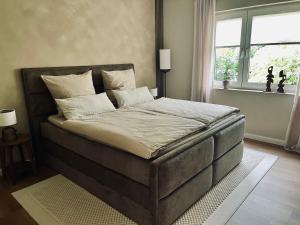 a large bed in a bedroom with a window at LIV Apartments in Stadthagen