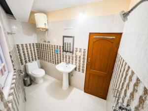 a bathroom with a toilet and a sink at Hotel White Yak Darjeeling in Darjeeling +24 photos