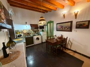 a kitchen with a table and a dining room at Country house La Virgy with exclusive pool and sea view in Avola