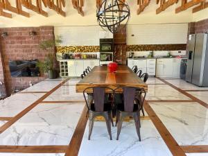 a large kitchen with a wooden table and chairs at Casa Lago Colbun in Talca
