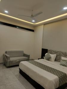 a hotel room with a bed and a couch at Hotel Raddizone in Gandhinagar