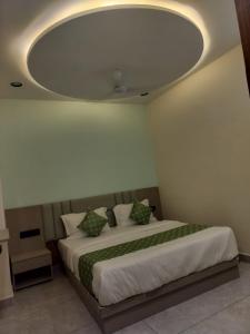 a bedroom with a large bed with a round ceiling at Hotel Raddizone in Gandhinagar