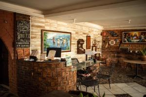 a bar in a restaurant with a brick wall at Recanto do caja in Porto De Galinhas
